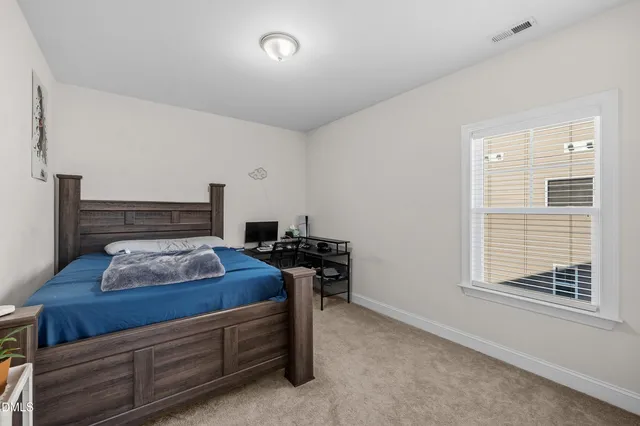 a bedroom with bed and window