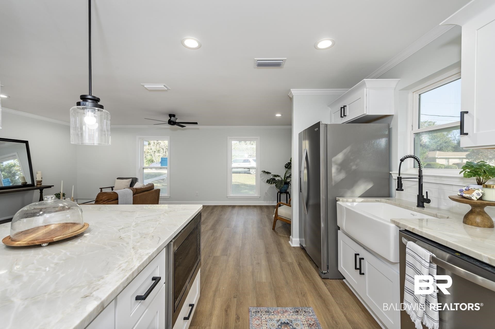 6001 Camp Halls Mill Road Mobile, AL 36619 - Photo 15 of 52 Kitchen featuring light stone countertops, ornamental molding, white cabinets, stainless steel appliances, and healthy amount of natural light