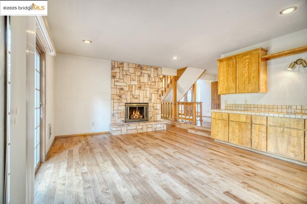 19195 Ferretti Road Groveland, CA 95321 - Photo 10 of 51 Unfurnished family room with light wood-type flooring, a fireplace, and recessed lighting.