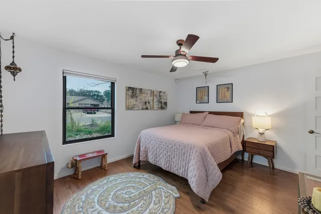 a bedroom with a large bed and a window