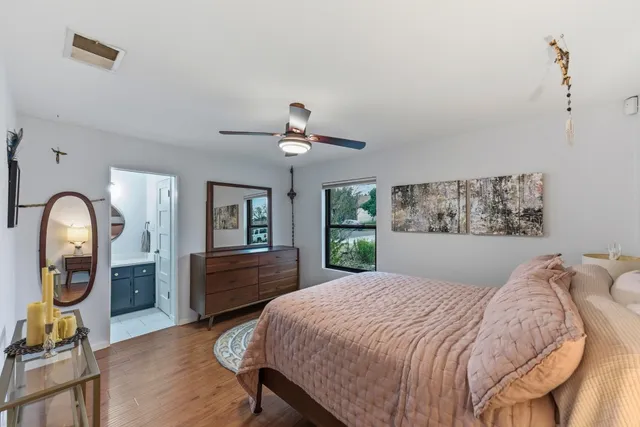 a bedroom with a large bed and a chandelier
