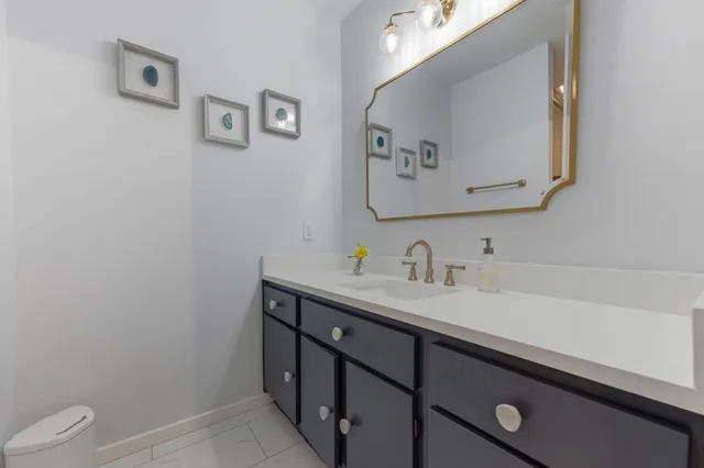 a bathroom with a sink vanity and a toilet