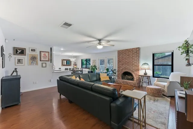 a living room with furniture a fireplace and a flat screen tv