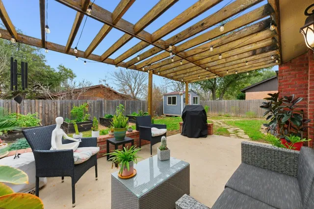 a view of a patio with couches table and chairs and potted plants
