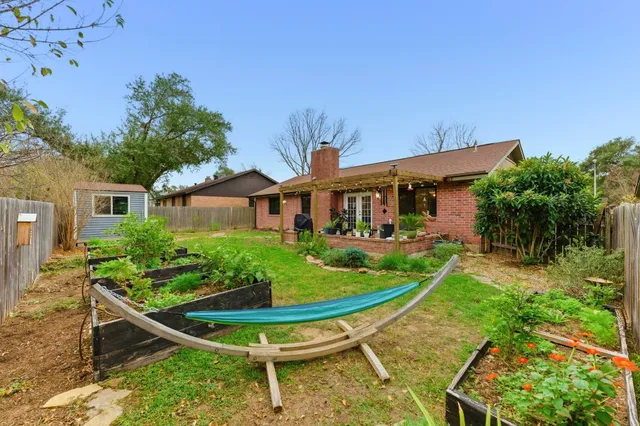 a front view of a house with a yard table and chairs
