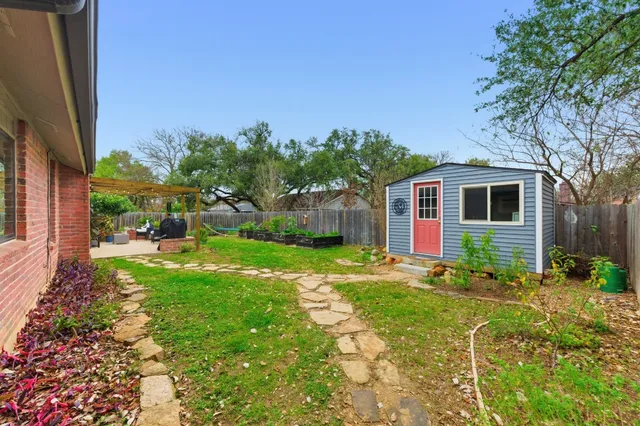 a backyard of a house with table and chairs