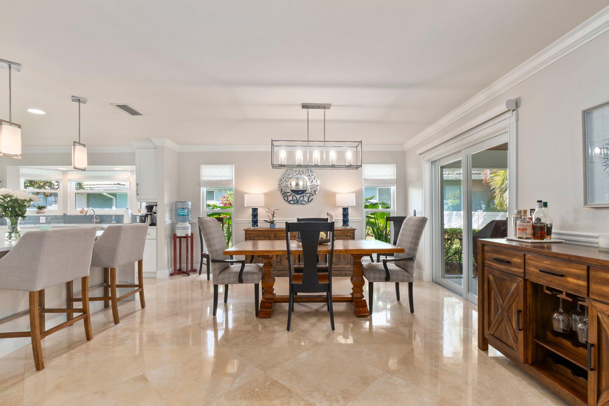 3142 Southeast Fairway West Stuart, FL 34997 - Photo 11 of 38 a view of a dining area with furniture window and wooden floor