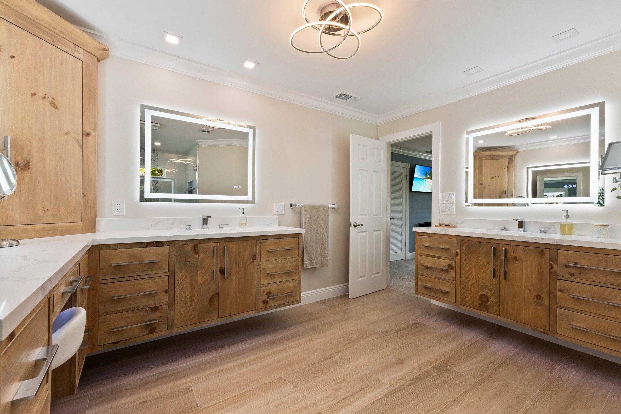 3142 Southeast Fairway West Stuart, FL 34997 - Photo 20 of 38 a spacious bathroom with double vanity sink a two mirror a window and a bathtub