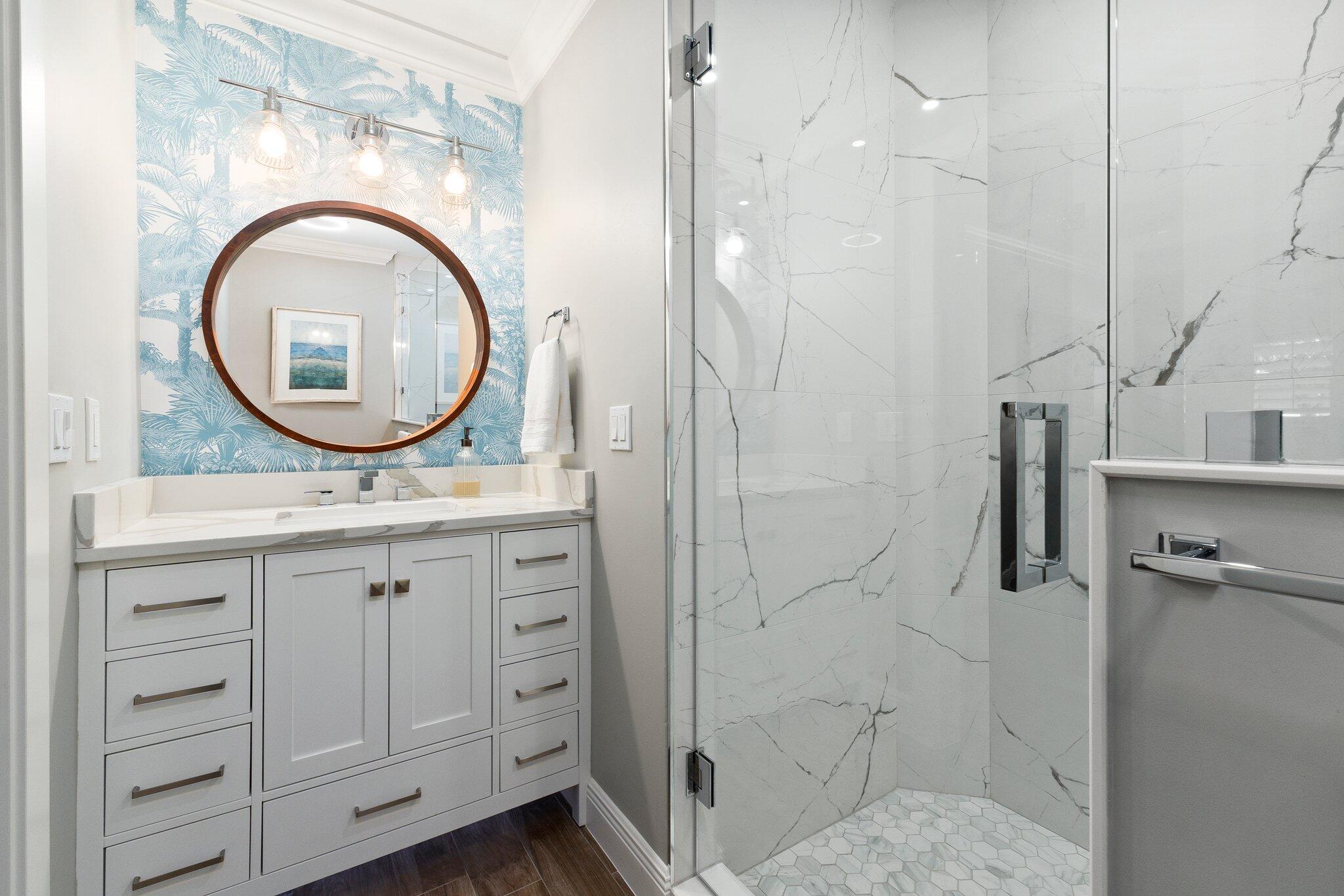3142 Southeast Fairway West Stuart, FL 34997 - Photo 22 of 38 a bathroom with a granite countertop sink a mirror and shower