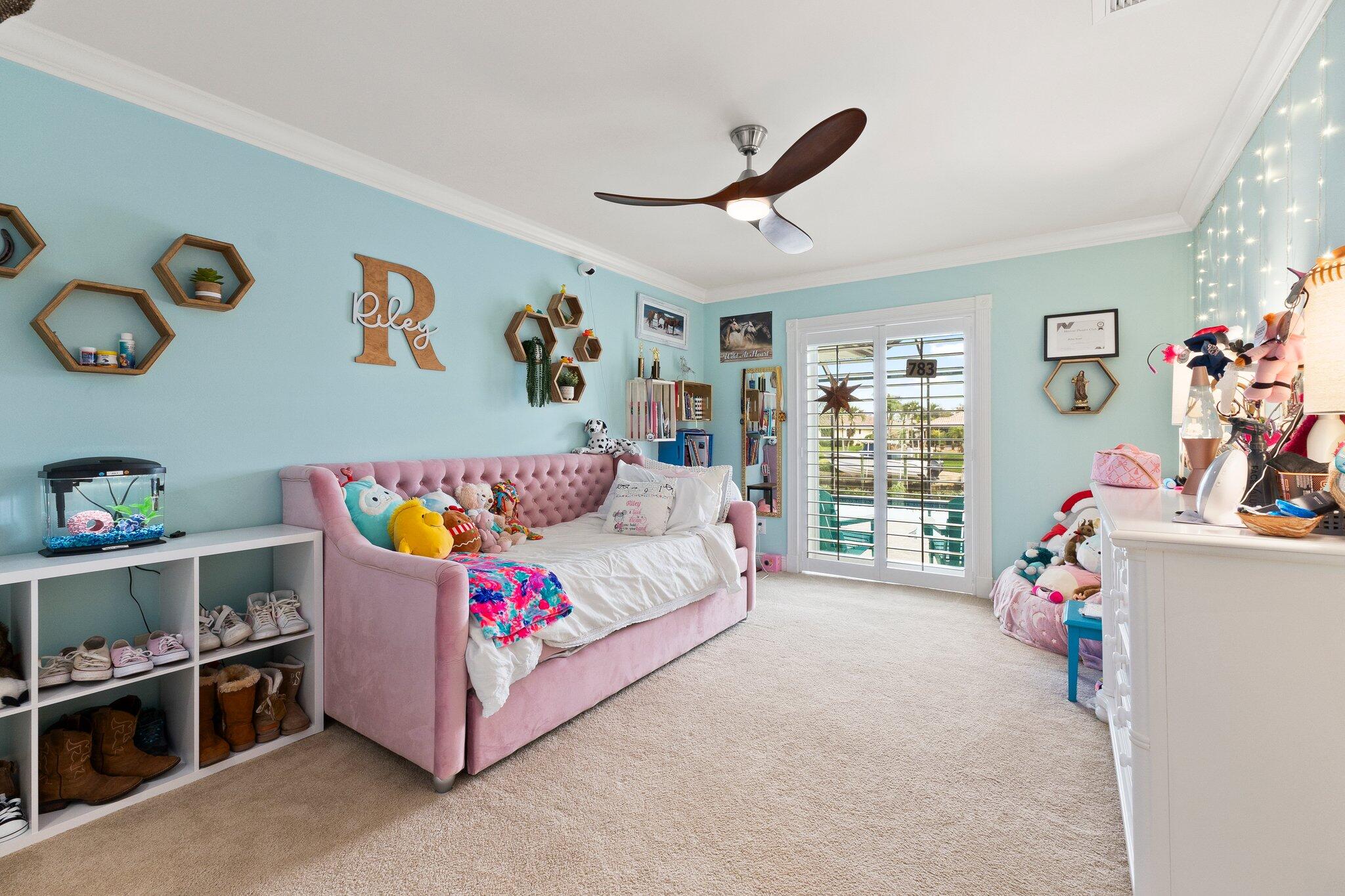 3142 Southeast Fairway West Stuart, FL 34997 - Photo 23 of 38 a bedroom with a bed and a window