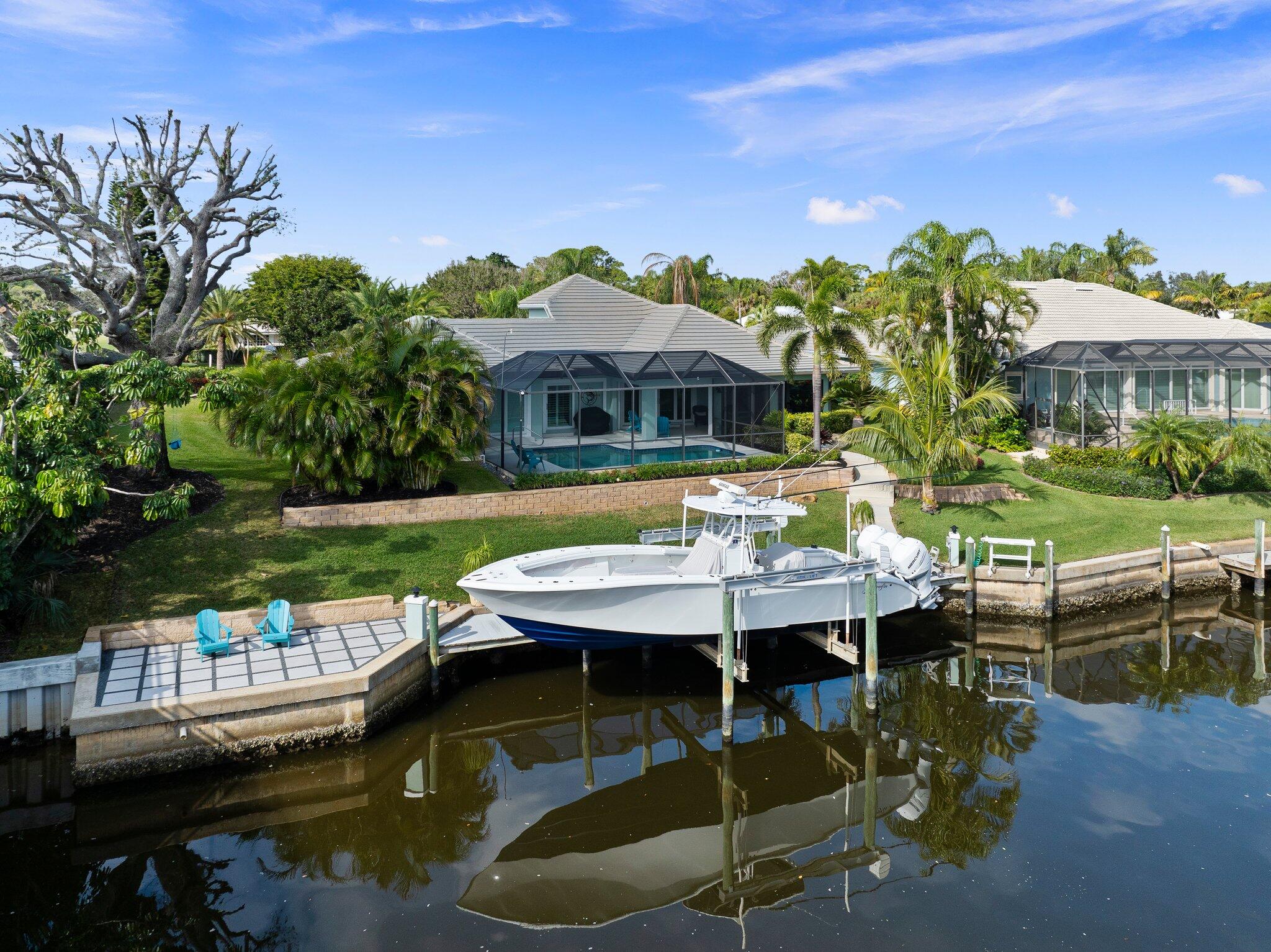 3142 Southeast Fairway West Stuart, FL 34997 - Photo 3 of 38 a view of a patio with table and chairs and potted plants