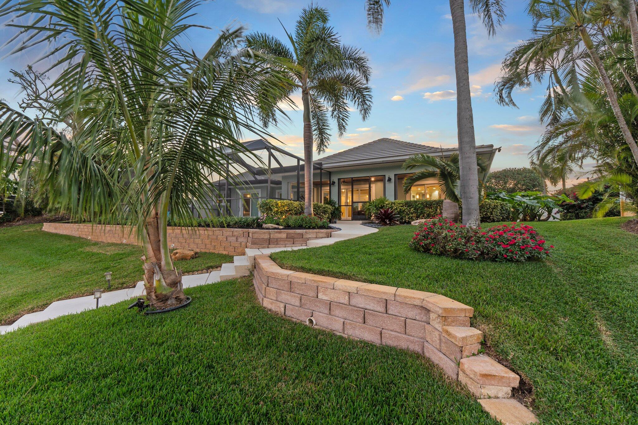3142 Southeast Fairway West Stuart, FL 34997 - Photo 36 of 38 a front view of a house with garden and tree