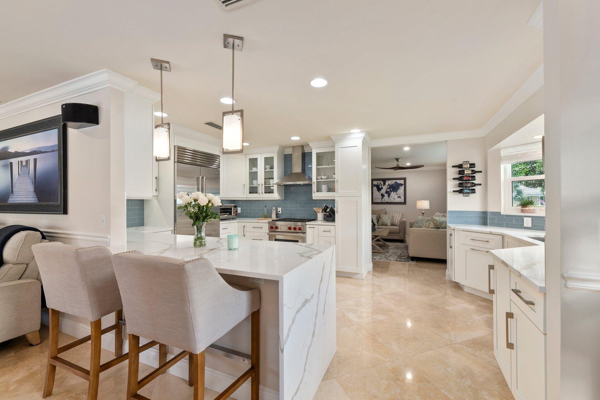3142 Southeast Fairway West Stuart, FL 34997 - Photo 4 of 38 a large kitchen with a table and chairs