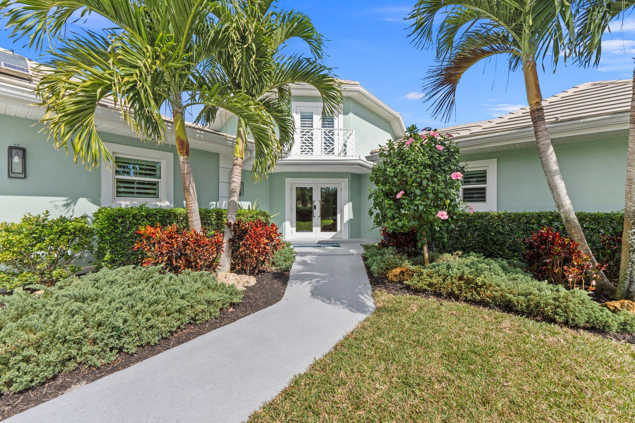3142 Southeast Fairway West Stuart, FL 34997 - Photo 8 of 38 front view of a house with a yard
