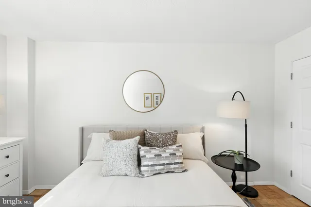 a bedroom with a bed and a lamp on the table