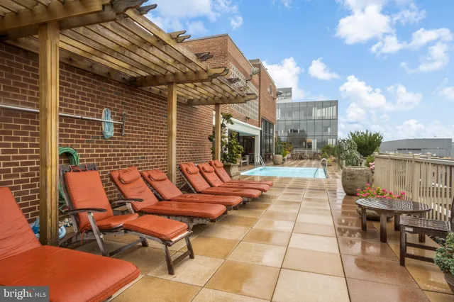 a view of a patio with table and chairs with wooden floor and fence