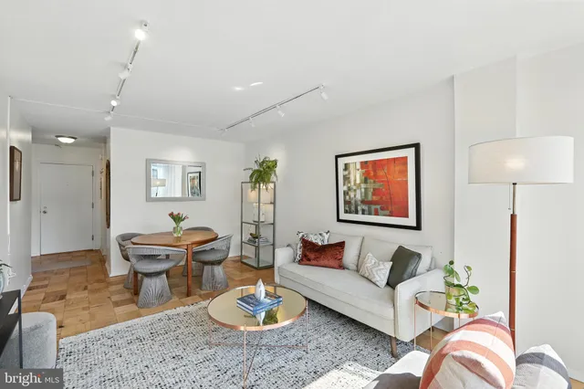 a living room with furniture and wooden floor