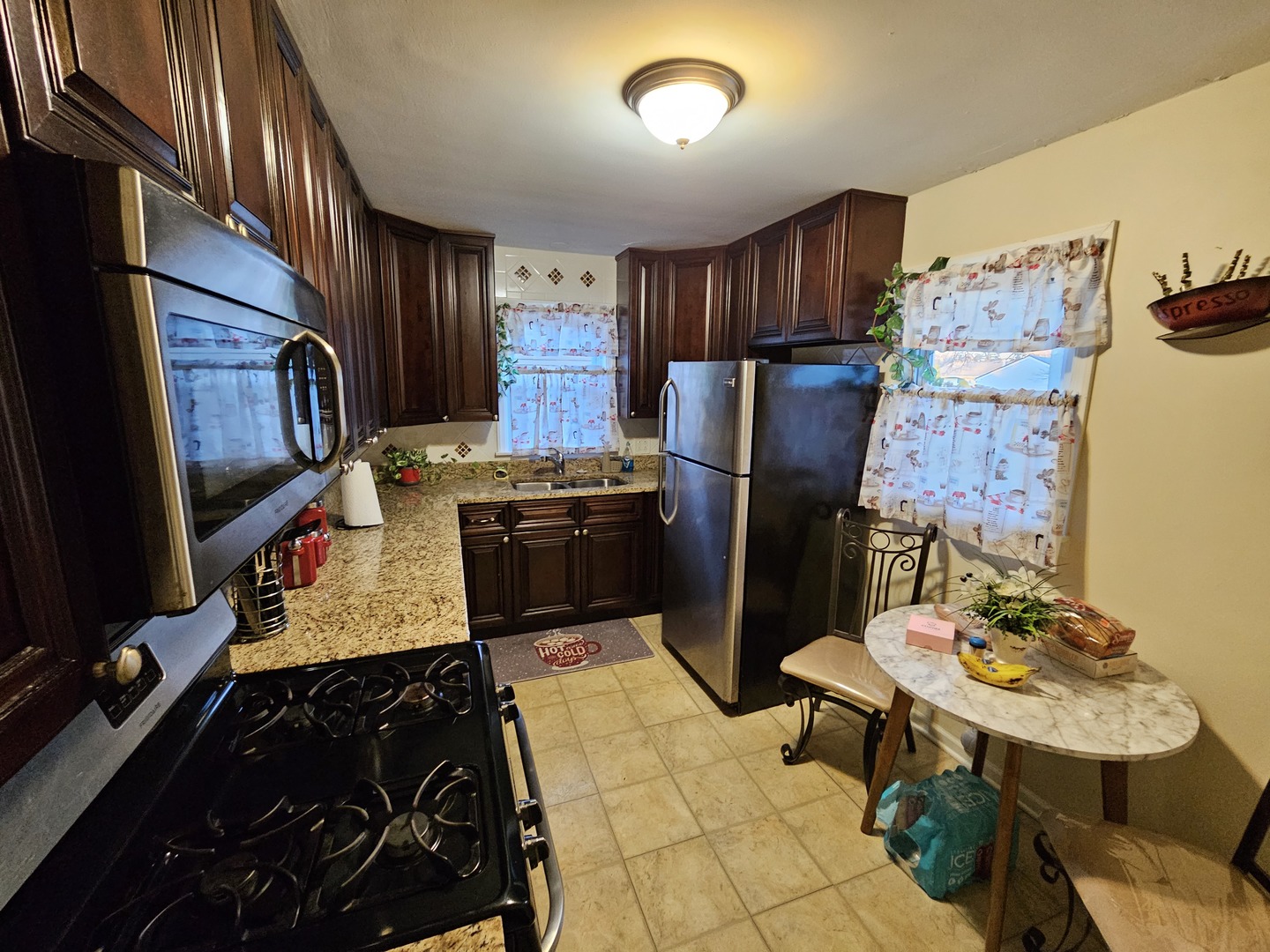239 South McLean Boulevard Elgin, IL 60123 - Photo 6 of 30 a kitchen with stainless steel appliances granite countertop a refrigerator stove and sink