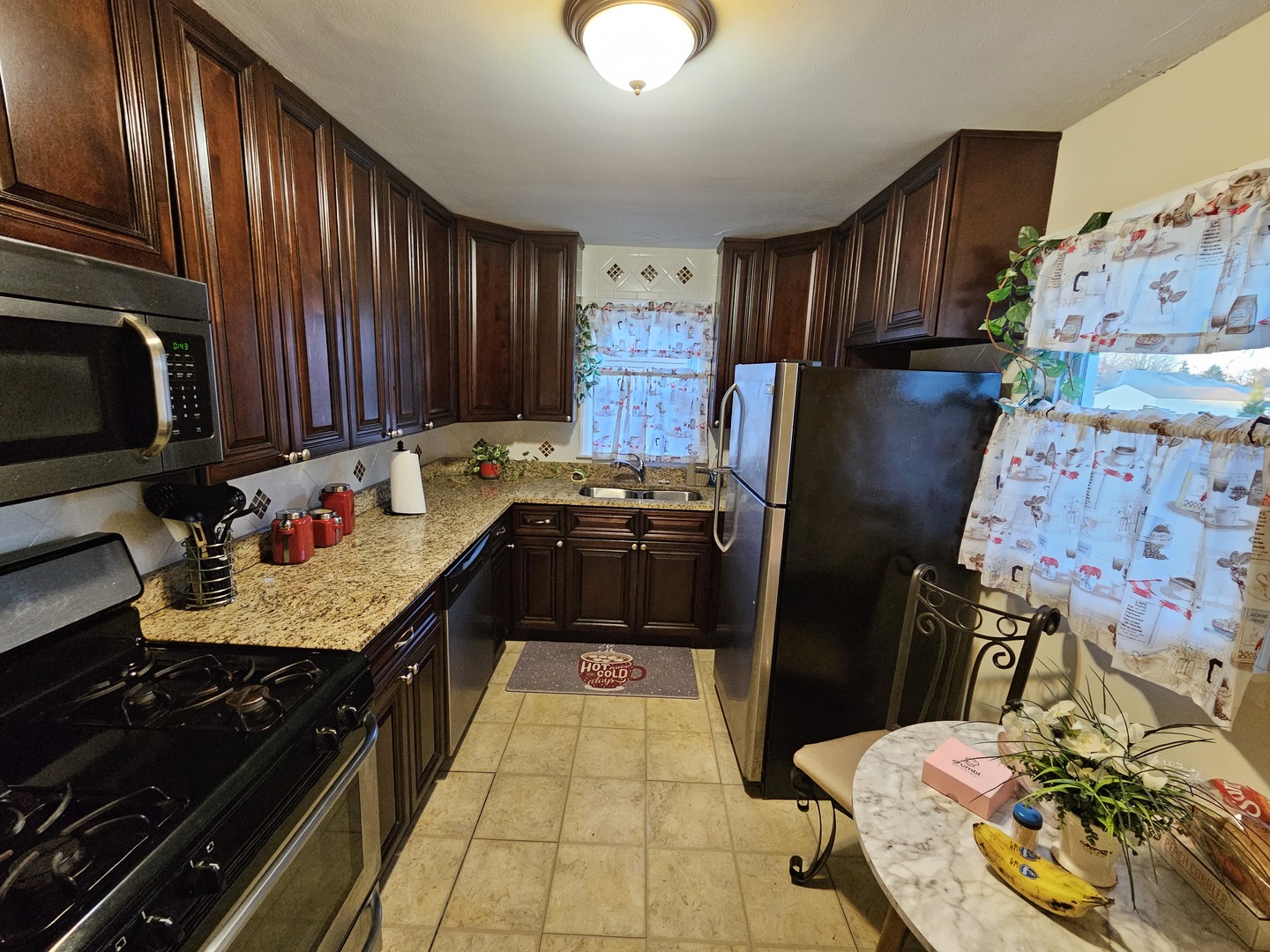 239 South McLean Boulevard Elgin, IL 60123 - Photo 7 of 30 a kitchen with a stove and a refrigerator