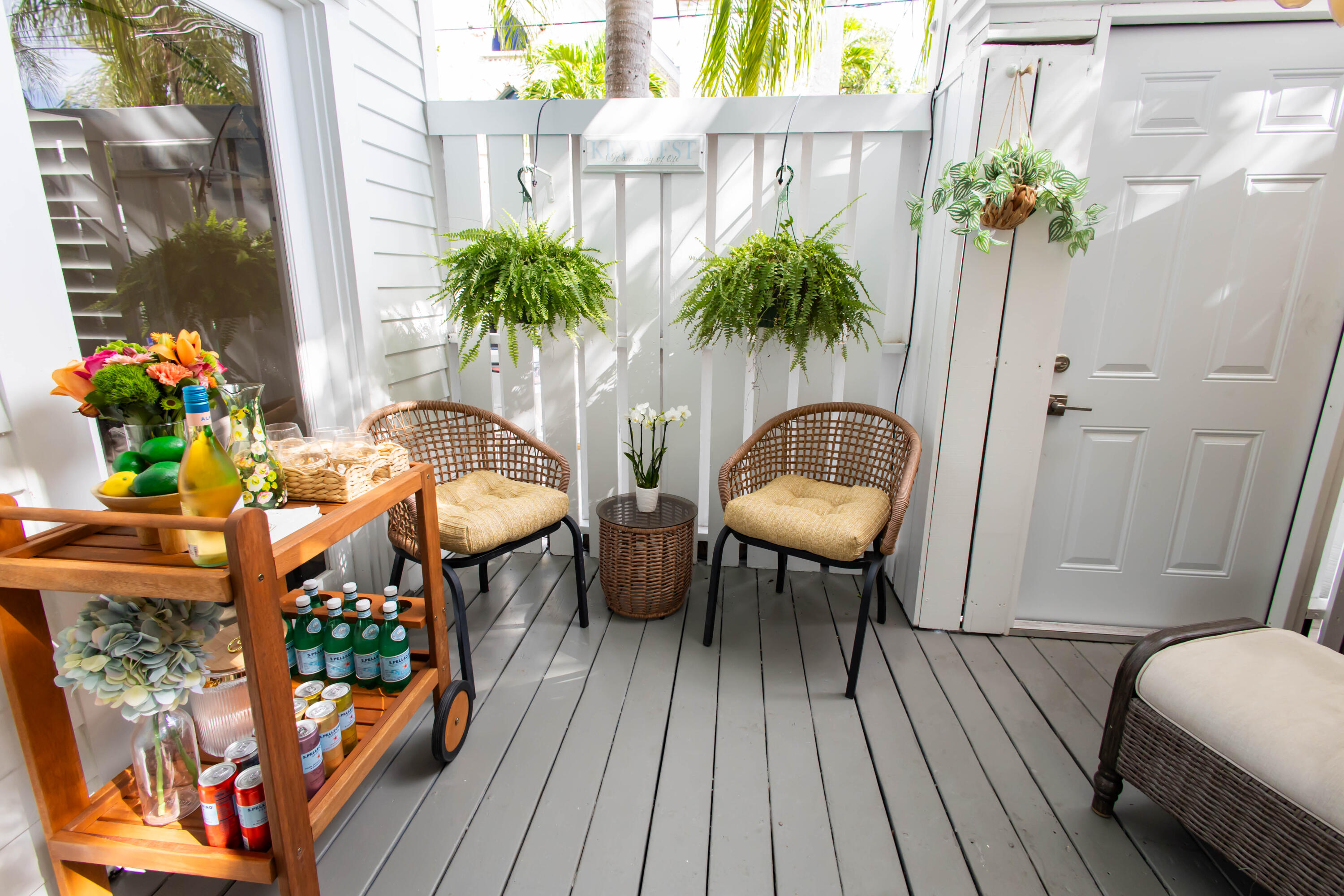1012 Whitehead Street Key West, FL 33040 - Photo 5 of 49 a balcony with potted plants and wooden floor