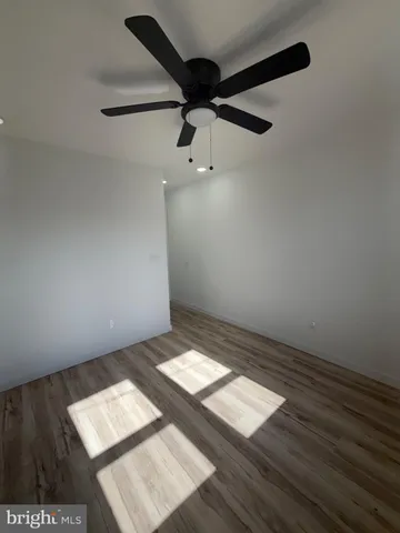 an empty room with wooden floor
