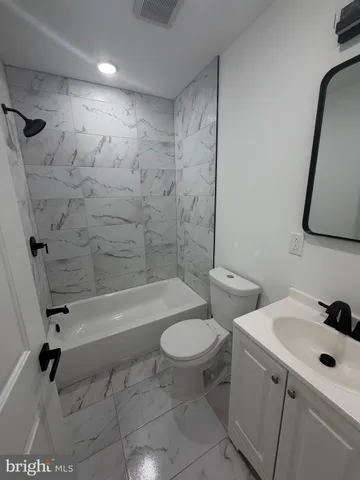 a bathroom with a sink a toilet and a bathtub