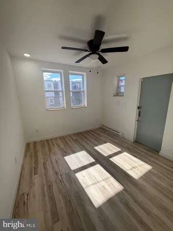 a view of wooden floor and windows in a room