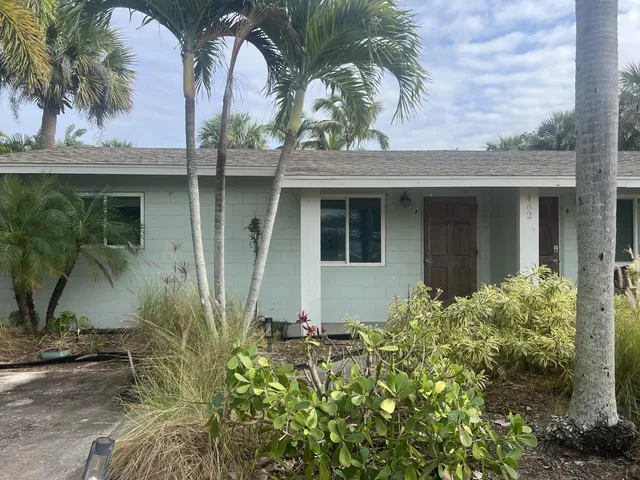 front view of house with potted plants