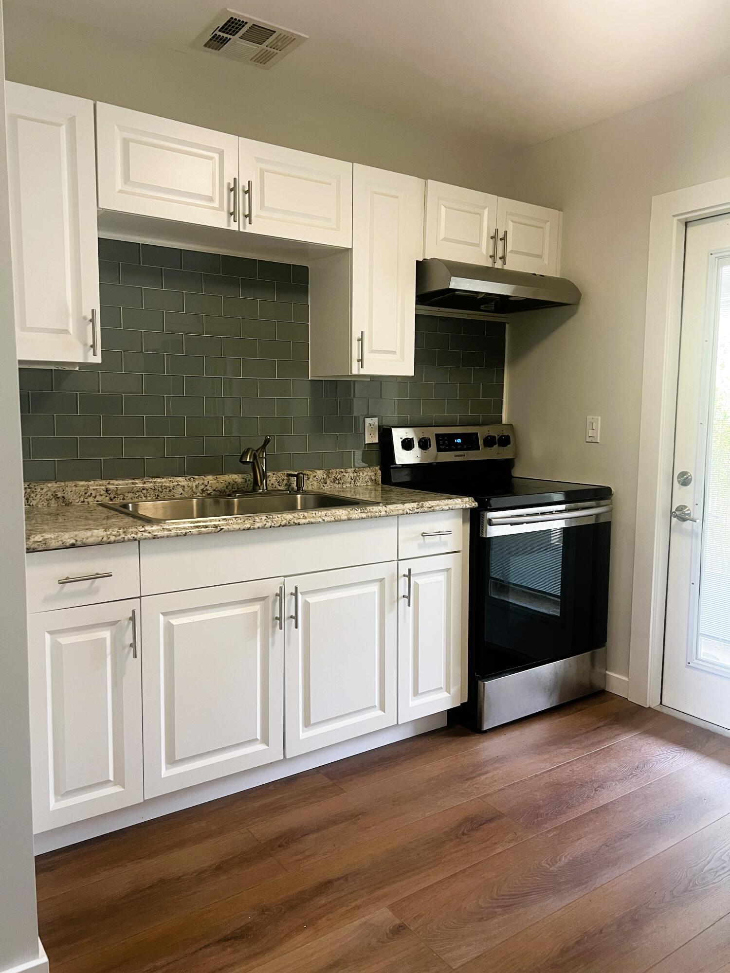 462 Granada Street, Unit A Fort Pierce, FL 34949 - Photo 2 of 10 a kitchen with stainless steel appliances granite countertop a sink stove and cabinets