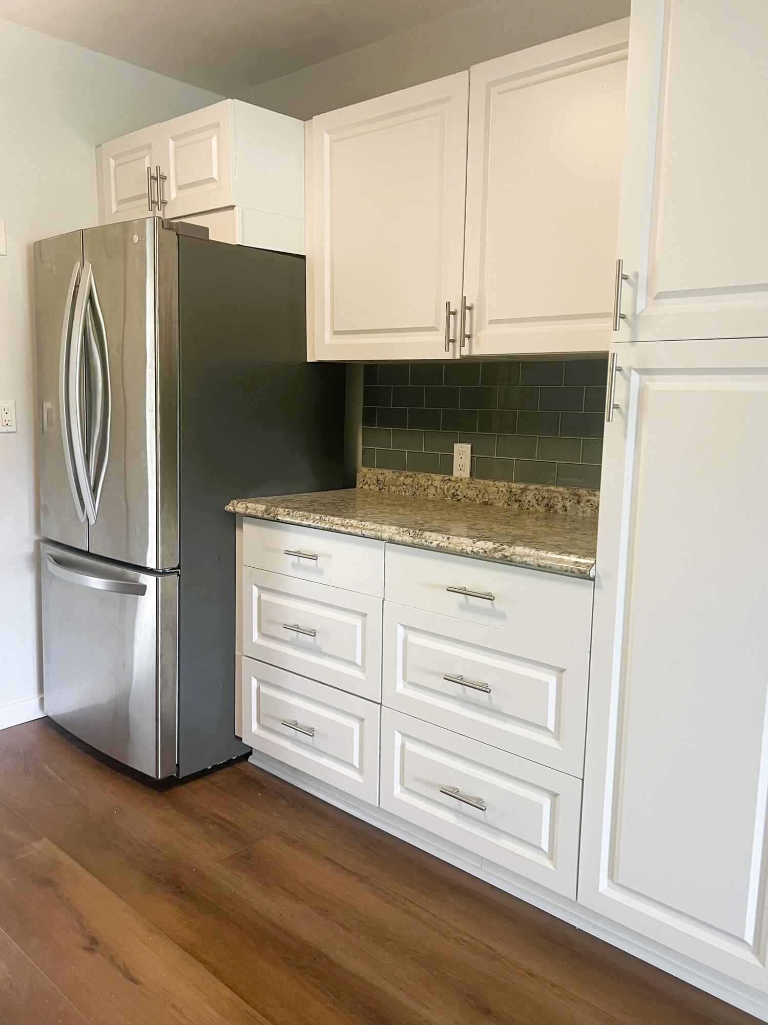 462 Granada Street, Unit A Fort Pierce, FL 34949 - Photo 3 of 10 a kitchen with granite countertop white cabinets and refrigerator