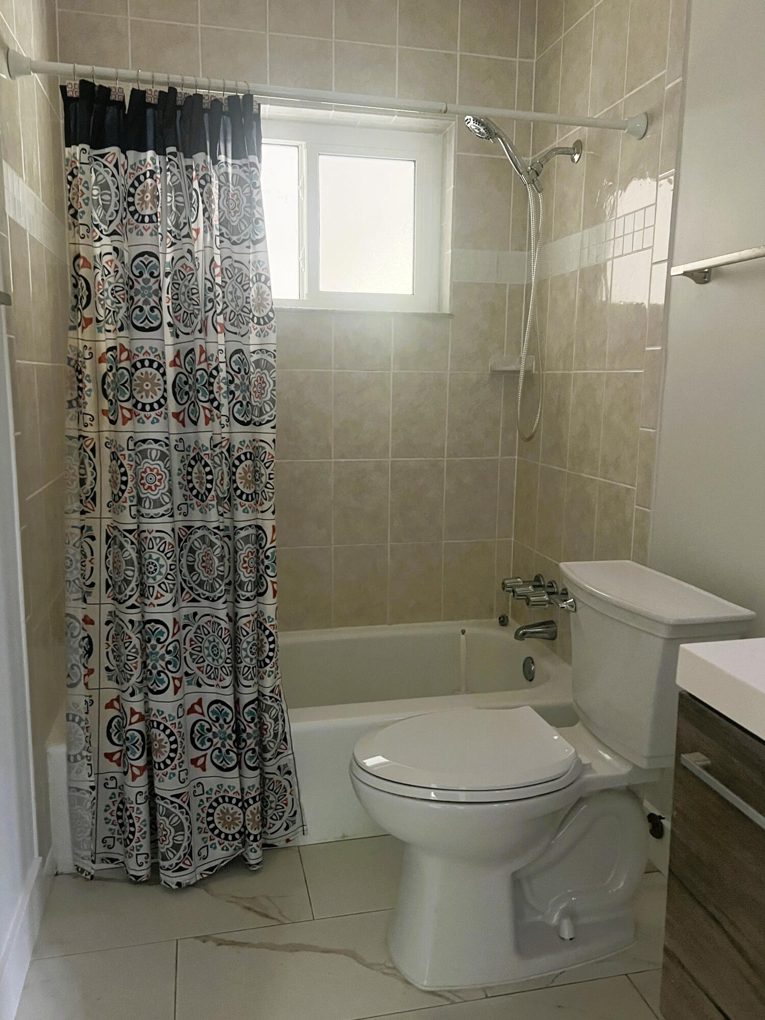 462 Granada Street, Unit A Fort Pierce, FL 34949 - Photo 7 of 10 a bathroom with a toilet and shower