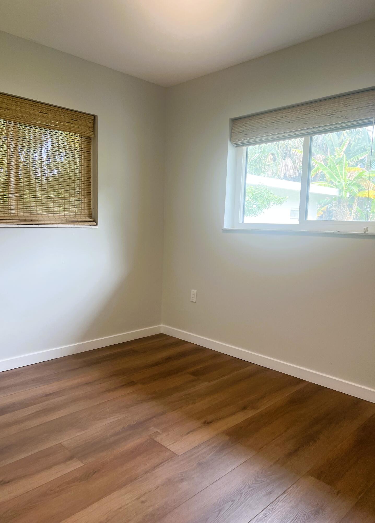 462 Granada Street, Unit A Fort Pierce, FL 34949 - Photo 8 of 10 a view of an empty room with wooden floor and a window