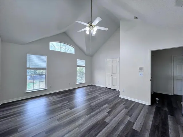 a view of a livingroom with wooden floor and a ceiling fan