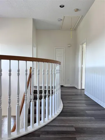 a view of wooden floor with staircase