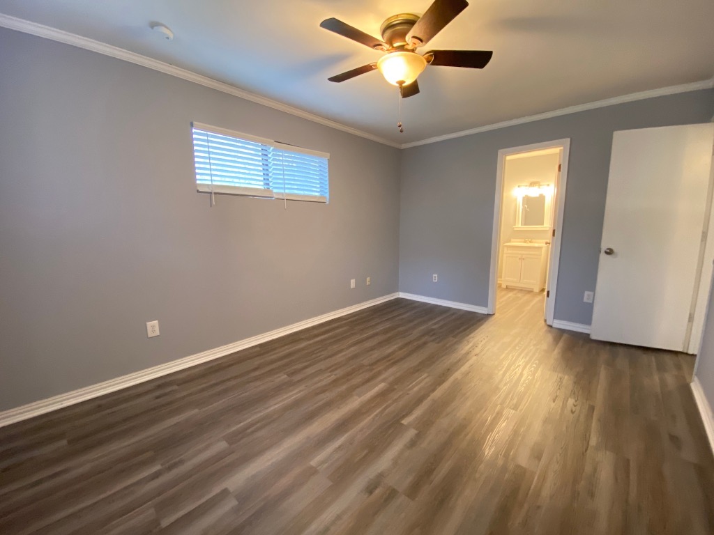 6211 Chesterfield Avenue, Unit B Austin, TX 78752 - Photo 13 of 24 a view of empty room with wooden floor and fan