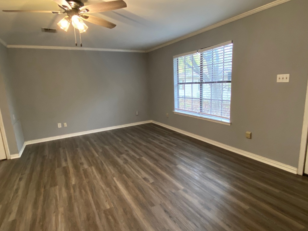 6211 Chesterfield Avenue, Unit B Austin, TX 78752 - Photo 17 of 24 wooden floor in an empty room with a window