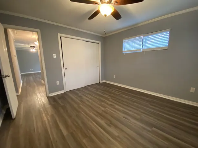wooden floor in an empty room with a window