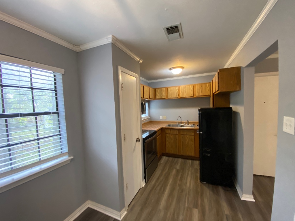 6211 Chesterfield Avenue, Unit B Austin, TX 78752 - Photo 5 of 24 a kitchen with a refrigerator and a stove
