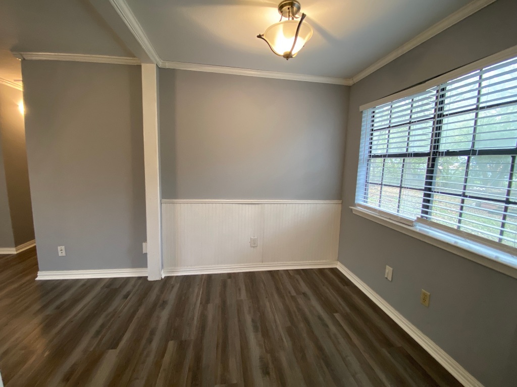 6211 Chesterfield Avenue, Unit B Austin, TX 78752 - Photo 8 of 24 an empty room with wooden floor and windows