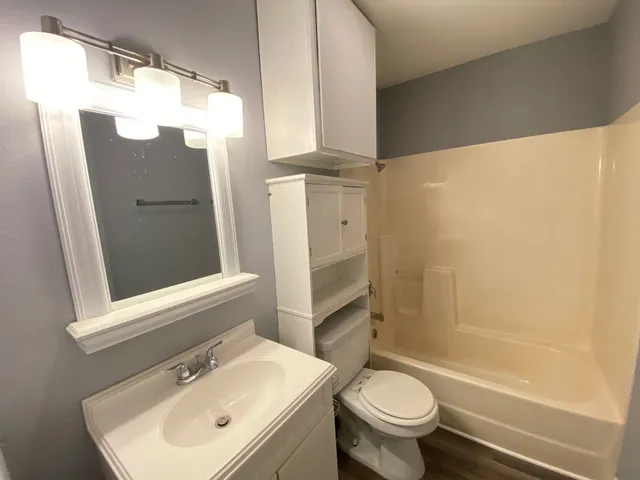 a bathroom with a sink toilet and shower