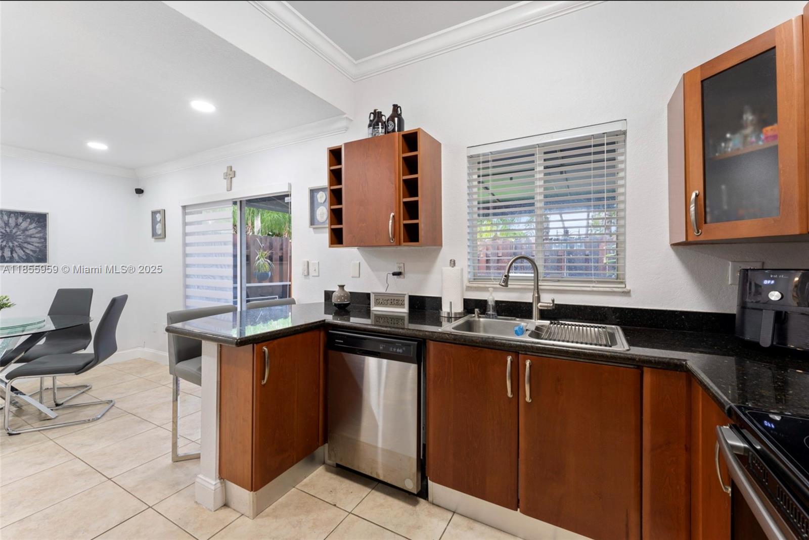 7423 Northwest 182nd Street Hialeah, FL 33015 - Photo 17 of 29 a kitchen with granite countertop a sink stove and cabinets