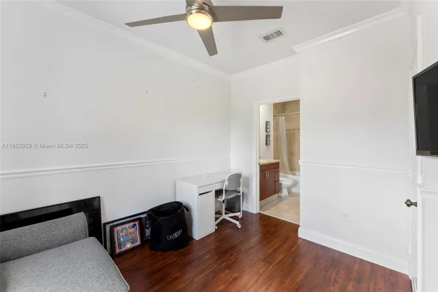 a bedroom with a bed and a wooden floor