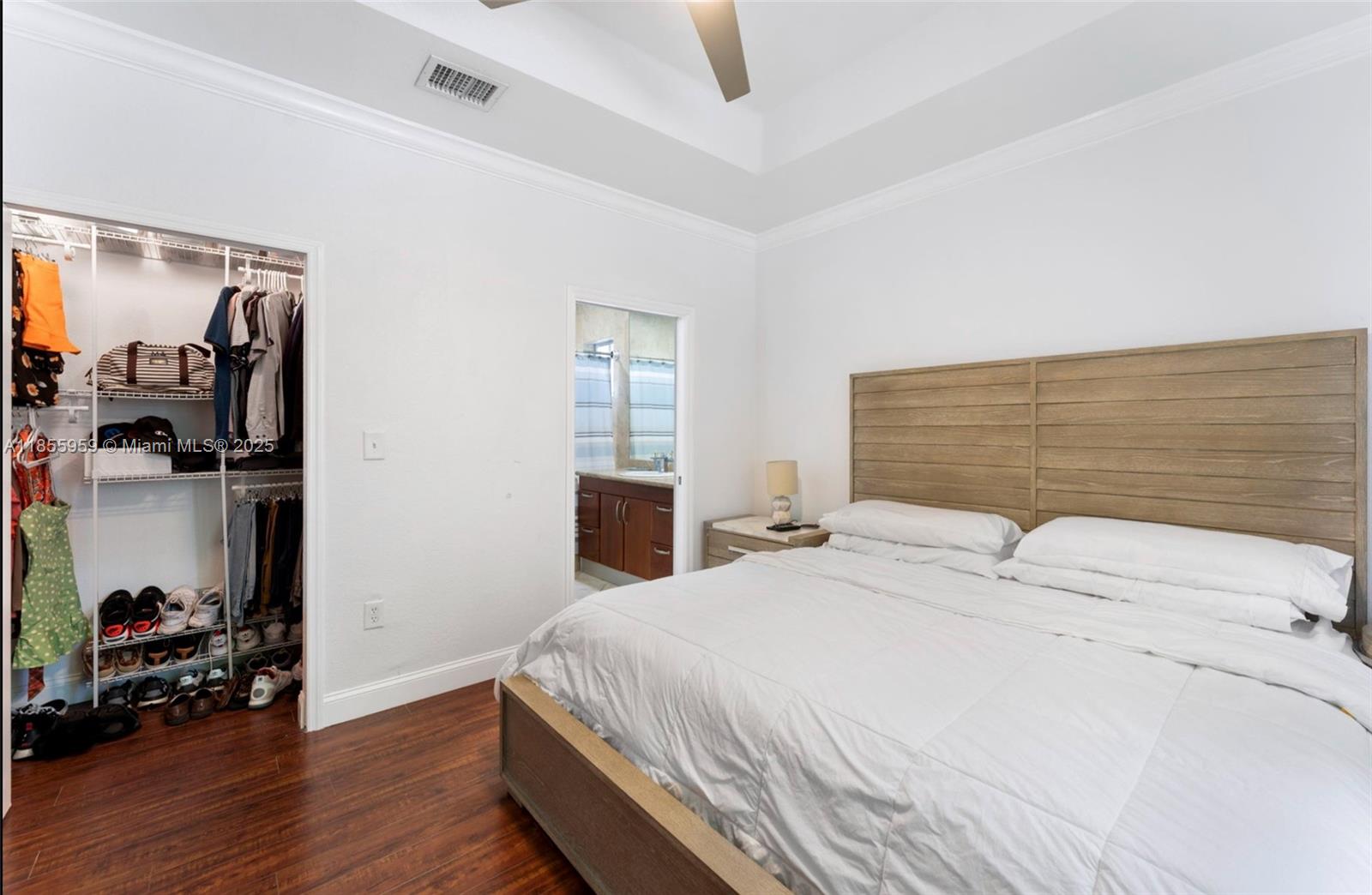 7423 Northwest 182nd Street Hialeah, FL 33015 - Photo 21 of 29 a bedroom with a bed and a wooden floor