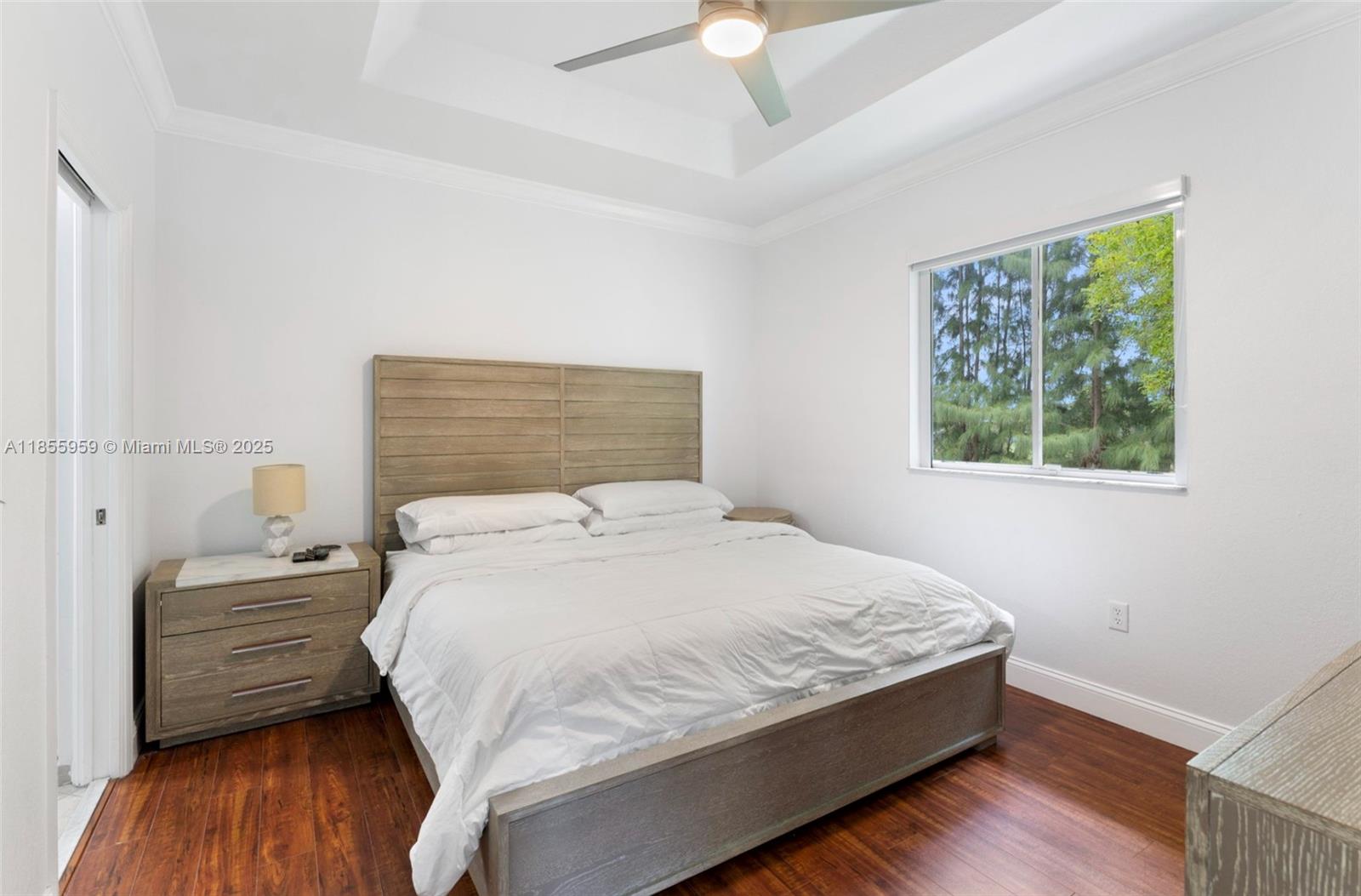 7423 Northwest 182nd Street Hialeah, FL 33015 - Photo 22 of 29 a bedroom with a bed wooden floor and window