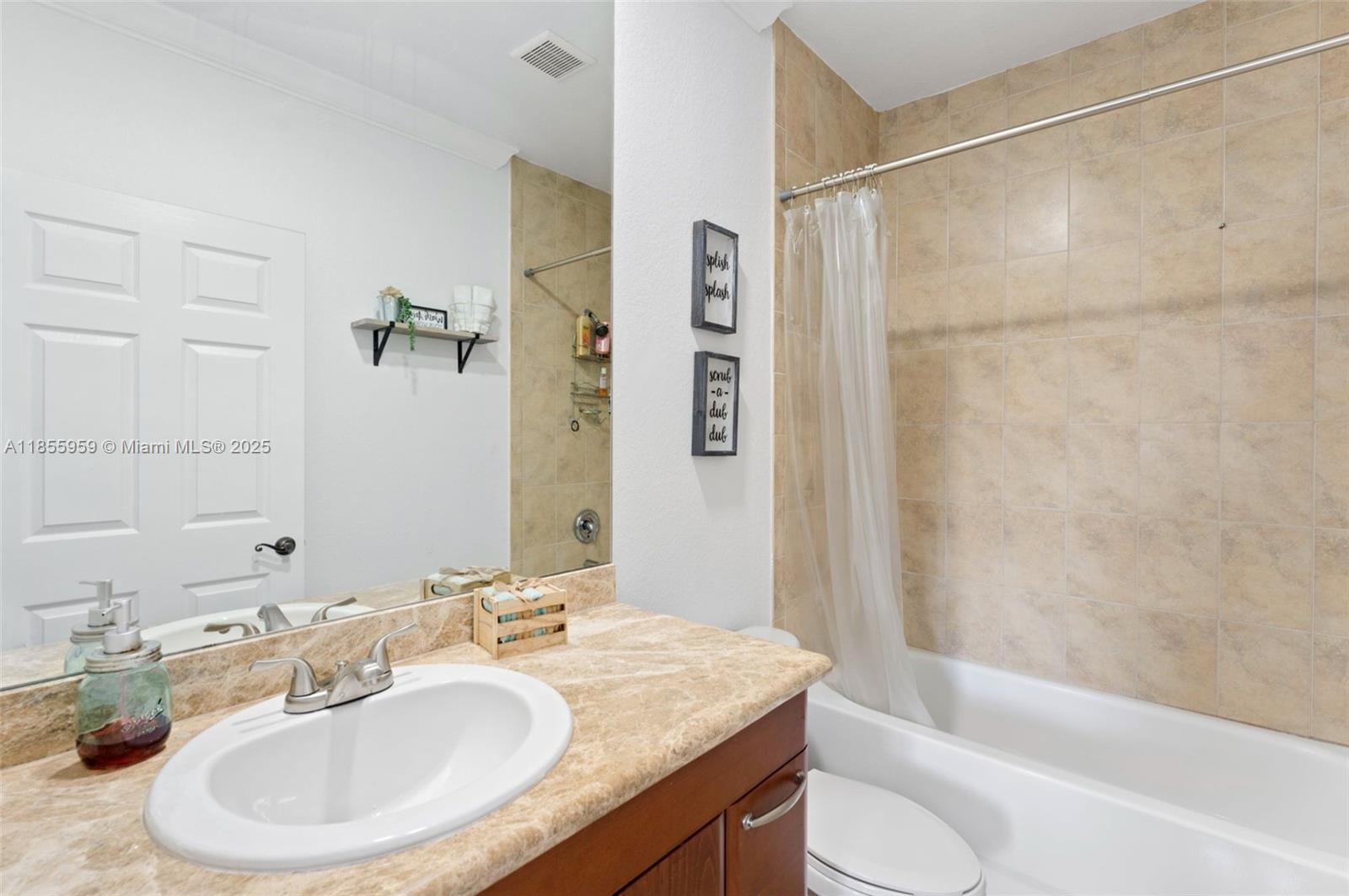 7423 Northwest 182nd Street Hialeah, FL 33015 - Photo 23 of 29 a bathroom with a granite countertop sink toilet and shower