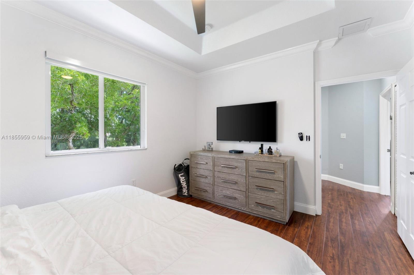 7423 Northwest 182nd Street Hialeah, FL 33015 - Photo 24 of 29 a bed room with flat screen tv and a window