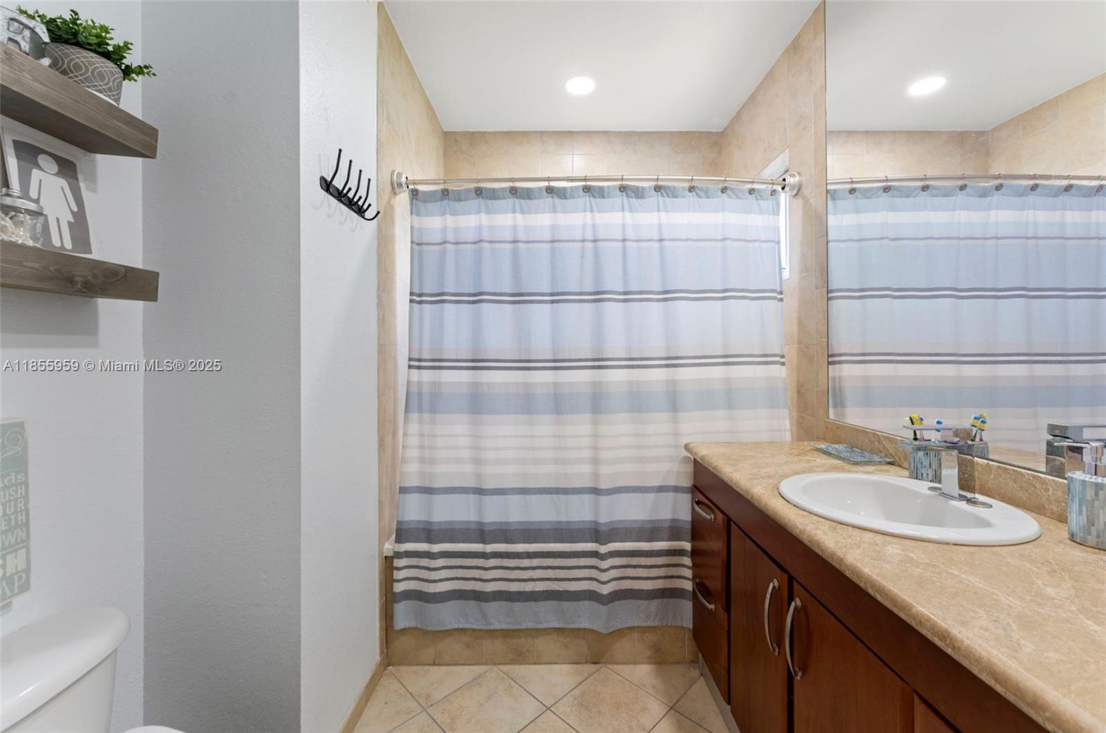 7423 Northwest 182nd Street Hialeah, FL 33015 - Photo 25 of 29 a bathroom with a sink shower and a mirror