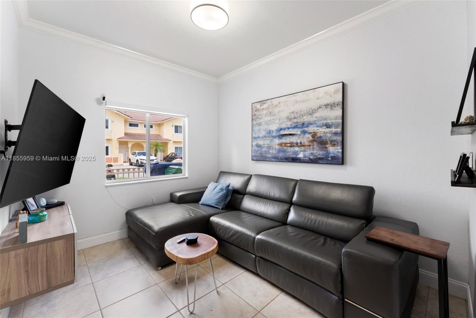 7423 Northwest 182nd Street Hialeah, FL 33015 - Photo 5 of 29 a living room with furniture and a flat screen tv