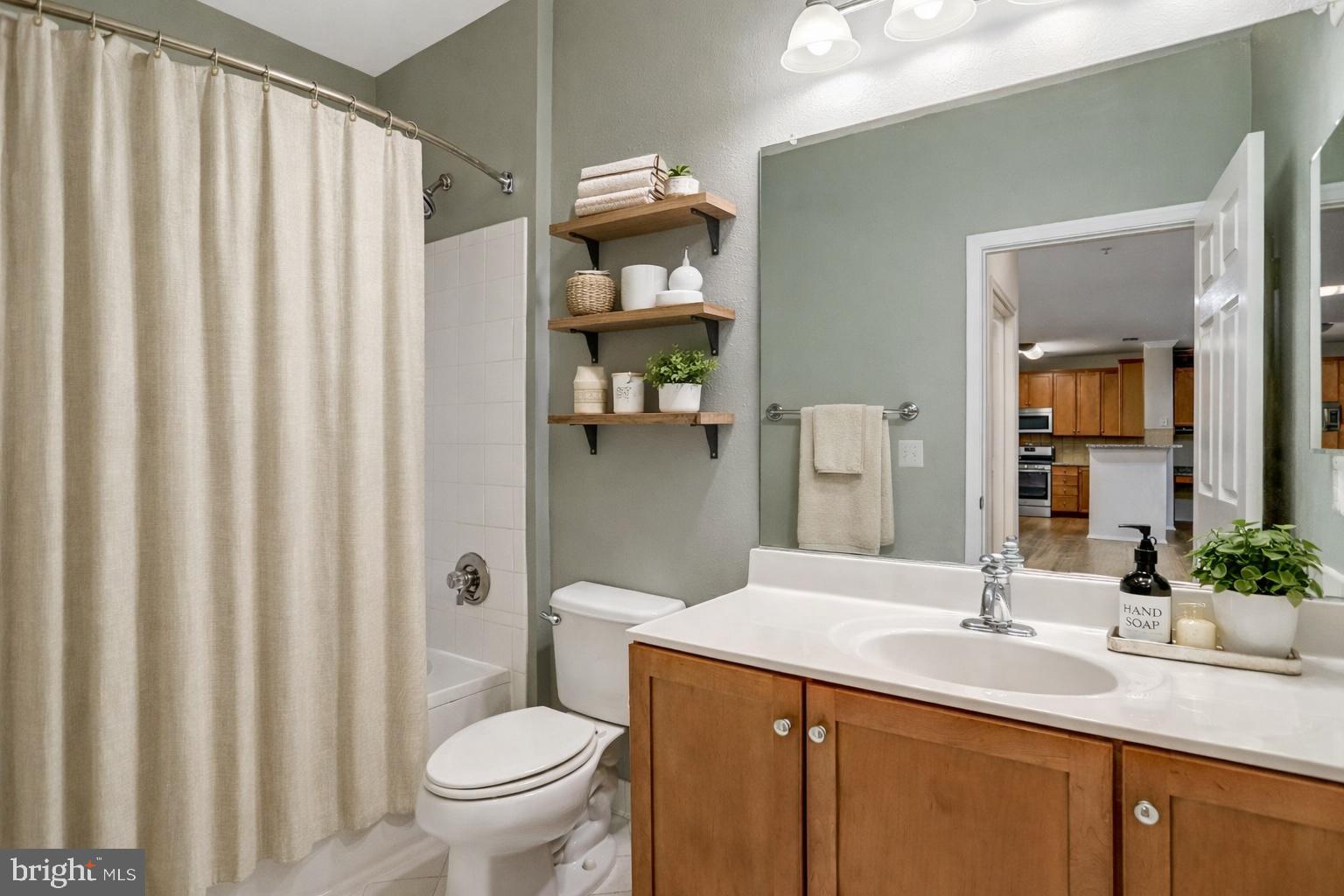 11800 Old Georgetown Road, Unit 1207 North Bethesda, MD 20852 - Photo 11 of 65 a bathroom with a sink a toilet and shower
