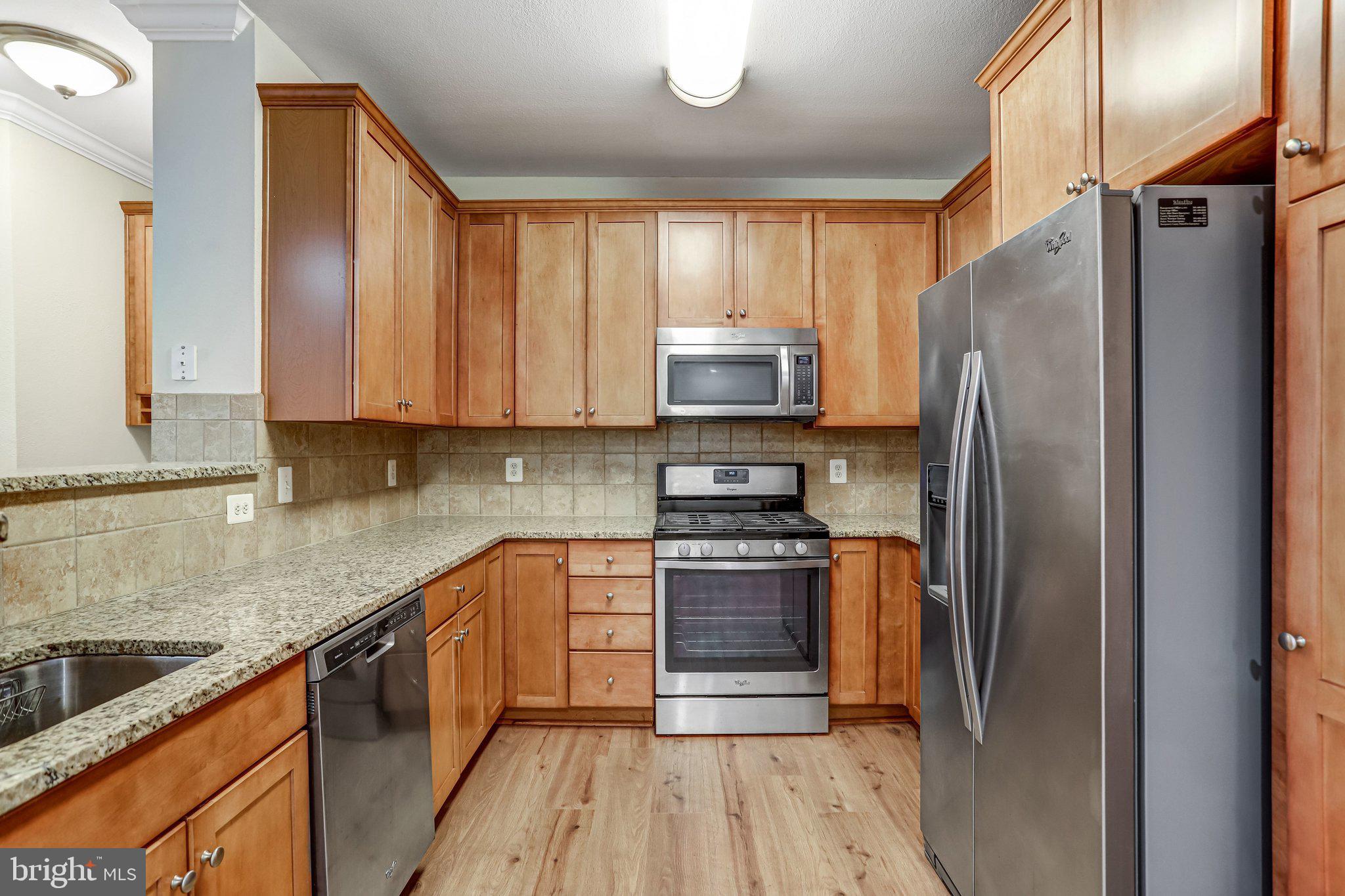 11800 Old Georgetown Road, Unit 1207 North Bethesda, MD 20852 - Photo 20 of 65 a kitchen with stainless steel appliances granite countertop a refrigerator stove and sink